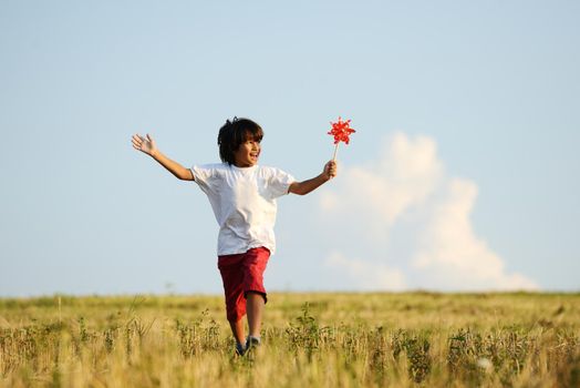 Happy kid running on beautiful field