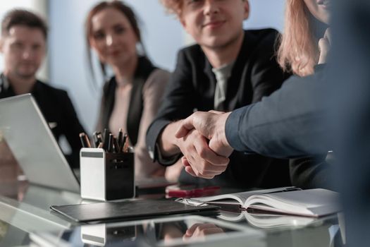 Male handshake closeup after effective negotiations showing mutual respect.