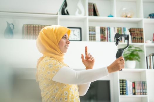 Muslim woman streaming video content online at home