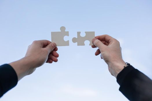 Closeup hand connecting jigsaw puzzle with, business solutions, success and strategy concept