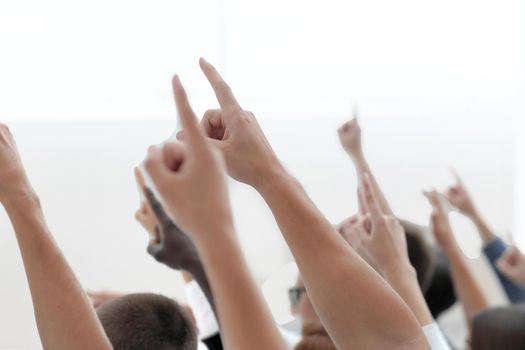 cropped image of a youth group pointing up. photo with copy space