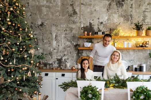 Young family celebrating Christmas at home. Happy young family enjoying their holiday time together.