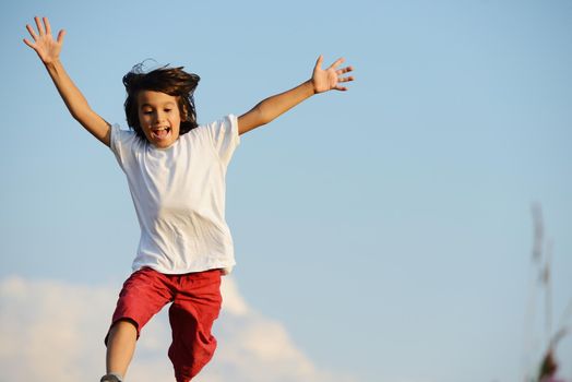 Happy kid running on beautiful field