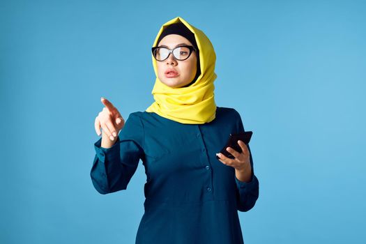 woman in yellow hijab technology calculator work finance. High quality photo