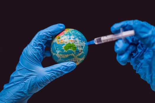 Syringe vaccinates the globe, on a map of the Australia. Australia Coronavirus, Corona virus attack concept. Australia fight against coronavirus. Concept of fight against coronavirus, danger and public health risk disease. Global Covid19 Vaccination Strategy concept. Vaccines against COVID.