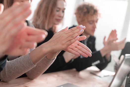 Business people clapping and applause at meeting or conference, close-up of hands.