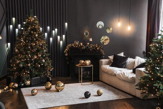 Christmas interior with a beautiful Christmas tree, sofa, light bulbs and dark background. Home New Year's interior.