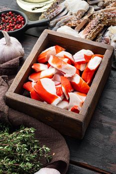 Asian snack surimi set, in wooden box, on dark wooden background