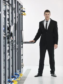 young handsome business man it  engeneer in datacenter server room