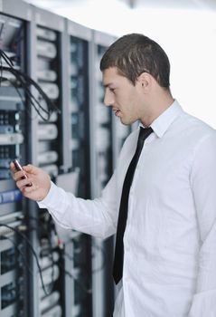 young handsome business man  engeneer in datacenter server room 