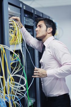 young handsome business man  engeneer in datacenter server room