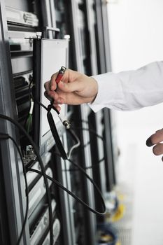 young handsome business man it  engeneer in datacenter server room