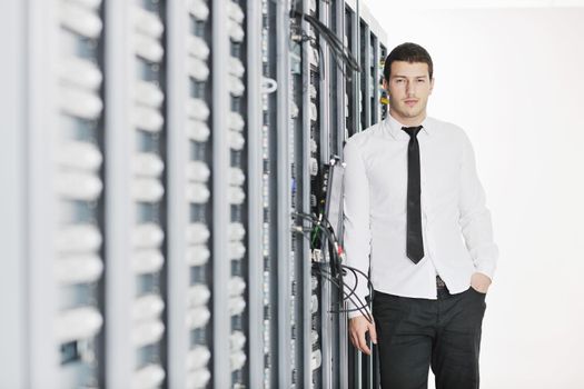 young handsome business man it  engeneer in datacenter server room