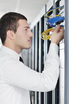 young handsome business man it  engeneer in datacenter server room