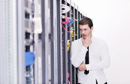 young handsome business man it  engeneer in datacenter server room