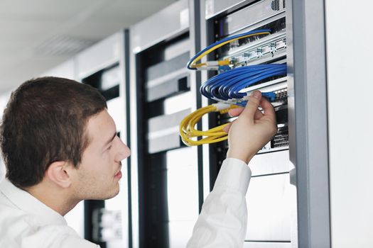 young handsome business man it  engeneer in datacenter server room