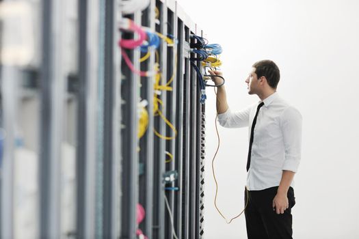 young handsome business man it  engeneer in datacenter server room