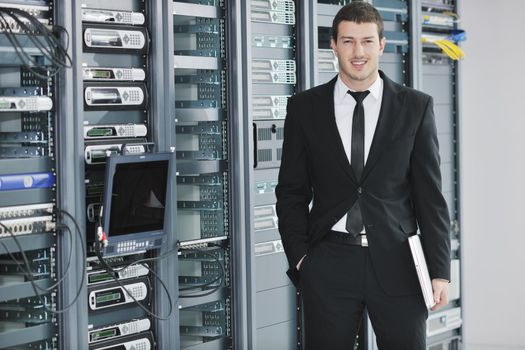 young handsome business man  engeneer in datacenter server room 