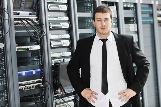 young handsome business man it  engeneer in datacenter server room