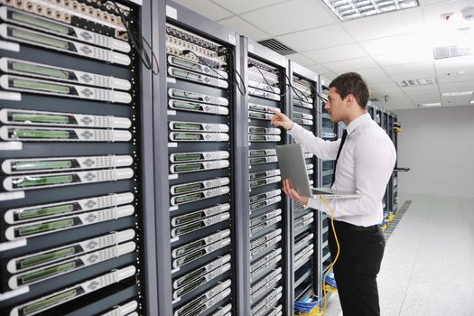 young handsome business man  engeneer in datacenter server room 