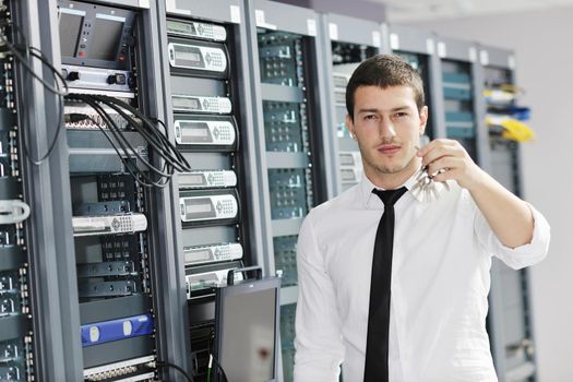 young handsome business man it engeneer in datacenter server room