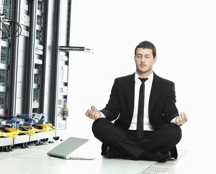 young it  engeneer business man with thin modern aluminium laptop in network server room