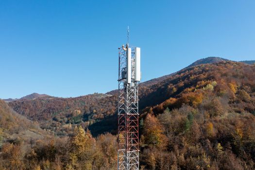 Telecommunications antenna tower in the morning. bright sunshine and blue sky with clouds. Transmitting antenna pairs. High quality photo