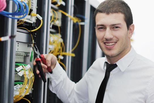 young handsome business man it  engeneer in datacenter server room