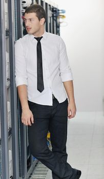 young handsome business man it  engeneer in datacenter server room