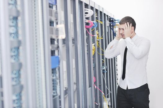 young handsome business man  engeneer in datacenter server room 