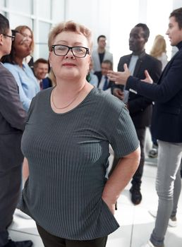 close up. confident business woman standing in a crowded office. photo with a copy-space.