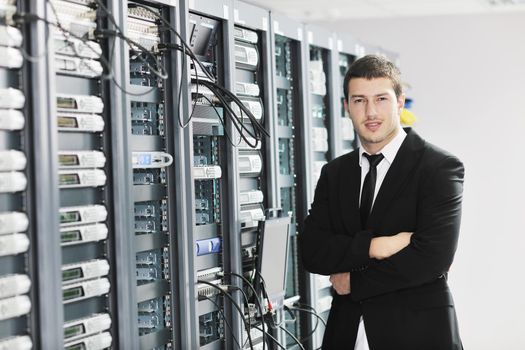 young handsome business man it  engeneer in datacenter server room