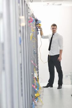 young handsome business man  engeneer in datacenter server room 