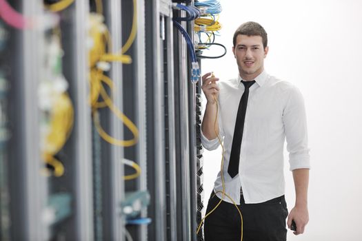 young handsome business man  engeneer in datacenter server room 