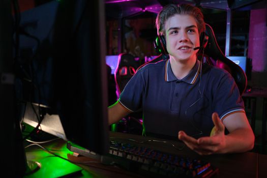 Professional photo of young male caucasian cyber sportsman in gaming club training for important match.
