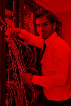 young handsome business man  engeneer in datacenter server room