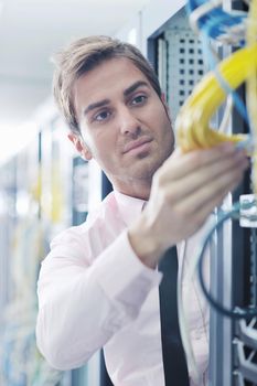 young handsome business man  engeneer in datacenter server room