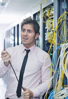 it business man in network server room have problems and looking for  disaster situation  solution