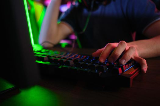 Close up view of professional players hands laying on gaming keyboard in gaming club or cyber arena