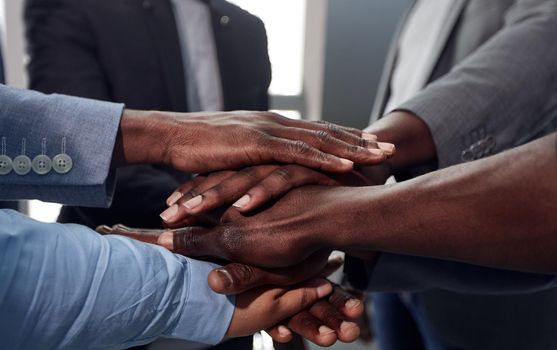 Group of diversity people hands stack support together in the office