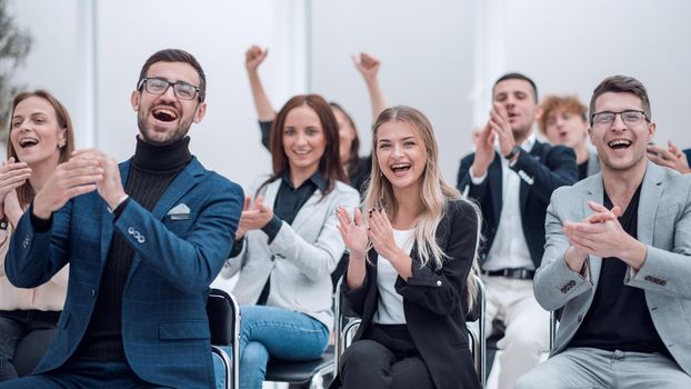 group of happy employees applauds in the conference room. the concept of success