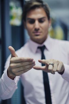 young handsome business man  engeneer in datacenter server room