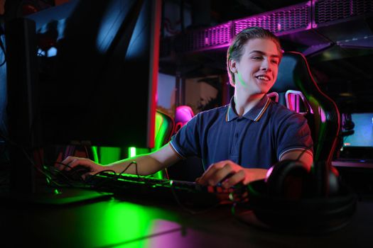Professional photo of young male caucasian cyber sportsman in gaming club training for important match.