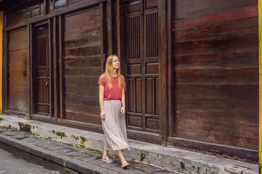 Woman tourist on background of Hoi An ancient town, Vietnam. Vietnam opens to tourists again after quarantine Coronovirus COVID 19.