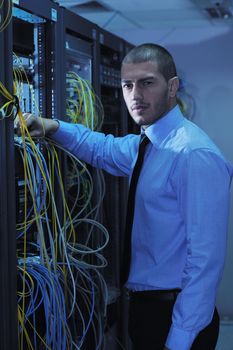 young handsome business man  engeneer in datacenter server room