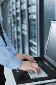 young handsome business man  engeneer in datacenter server room