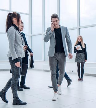 group of different business people passing in the office lobby. business concept