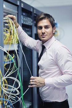 young handsome business man  engeneer in datacenter server room