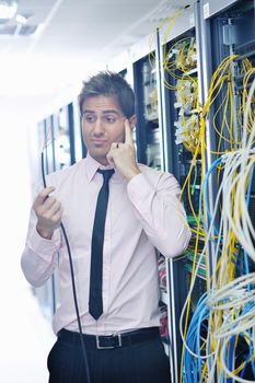 it business man in network server room have problems and looking for  disaster situation  solution