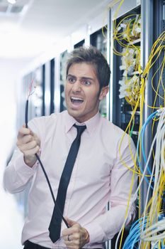 it business man in network server room have problems and looking for  disaster situation  solution